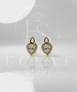 aretes tipo topo con diseño de cruz y circonias